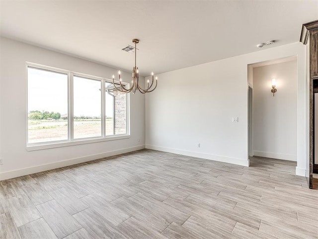6881 Lake View Ct, Cashion, OK 73016 - empty room with a chandelier and light wood-type flooring