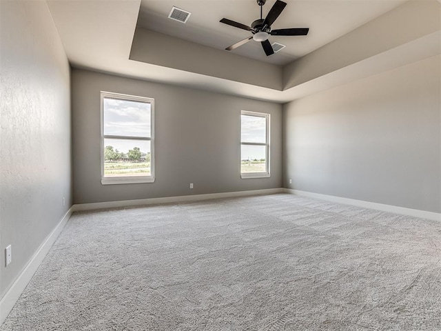 6881 Lake View Ct, Cashion, OK 73016 - carpeted empty room with a tray ceiling and ceiling fan