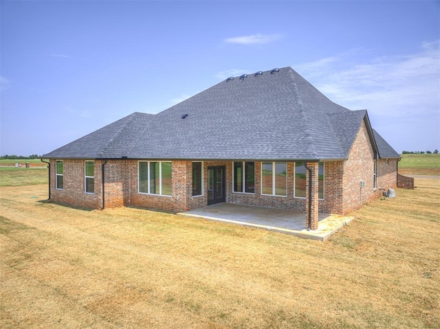 6881 Lake View Ct, Cashion, OK 73016 - back of house with a shingled roof, a patio area, brick siding, and a lawn