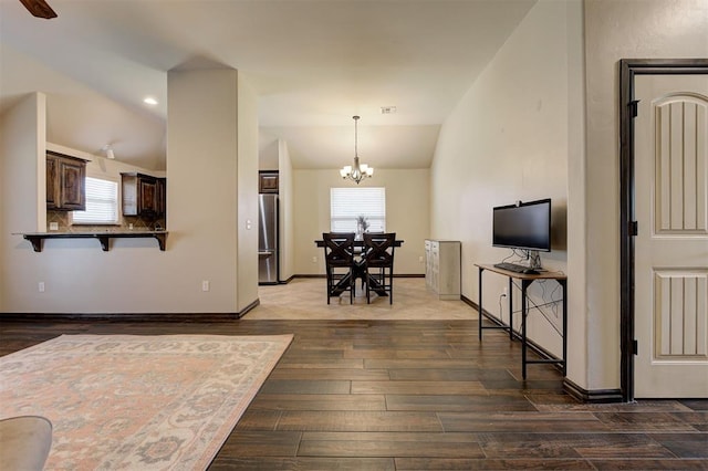2305 Makaila Way, Yukon, OK 73099 - living area featuring lofted ceiling, a chandelier, wood finished floors, and recessed lighting