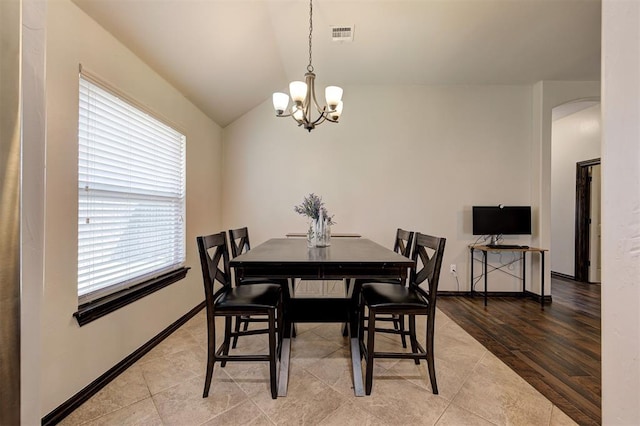 2305 Makaila Way, Yukon, OK 73099 - tiled dining room with a chandelier, arched walkways, and lofted ceiling