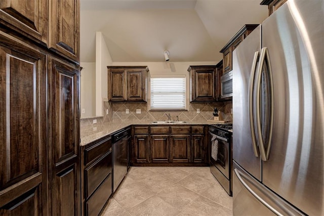 2305 Makaila Way, Yukon, OK 73099 - kitchen with appliances with stainless steel finishes, decorative backsplash, vaulted ceiling, dark brown cabinetry, and light tile patterned floors