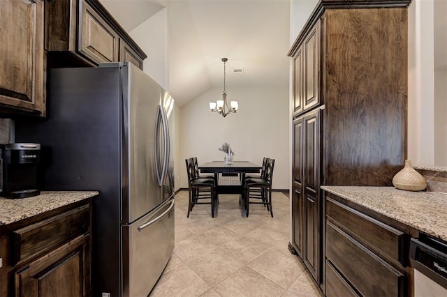 2305 Makaila Way, Yukon, OK 73099 - kitchen featuring stainless steel appliances, a chandelier, dark brown cabinets, vaulted ceiling, and light stone counters