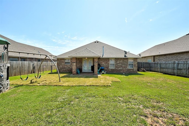 2305 Makaila Way, Yukon, OK 73099 - rear view of house featuring brick siding, a fenced backyard, and a shingled roof