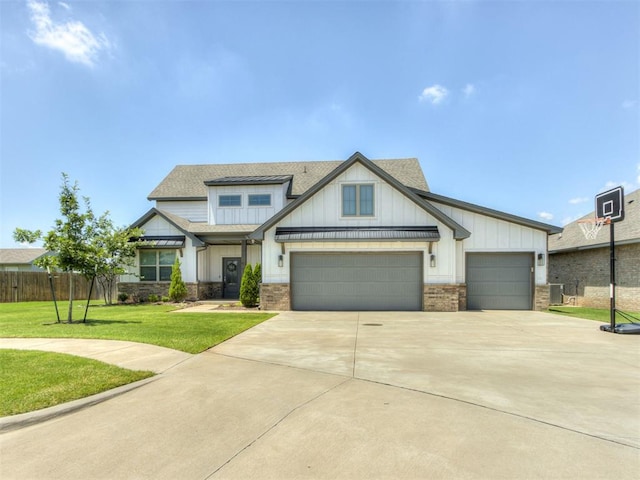 1391 Hickory Trl, Piedmont, OK 73078 - view of front facade with board and batten siding, concrete driveway, an attached garage, and a shingled roof
