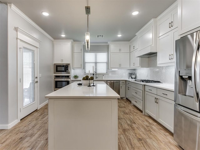 1391 Hickory Trl, Piedmont, OK 73078 - kitchen featuring stainless steel appliances, ornamental molding, light countertops, light wood finished floors, and backsplash