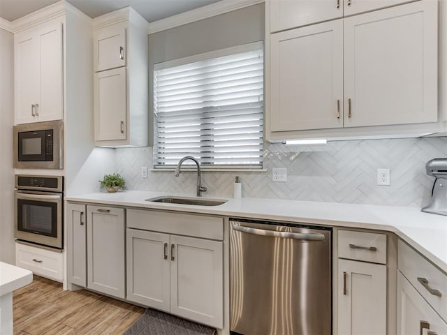 1391 Hickory Trl, Piedmont, OK 73078 - kitchen with appliances with stainless steel finishes, light countertops, decorative backsplash, light wood-type flooring, and ornamental molding