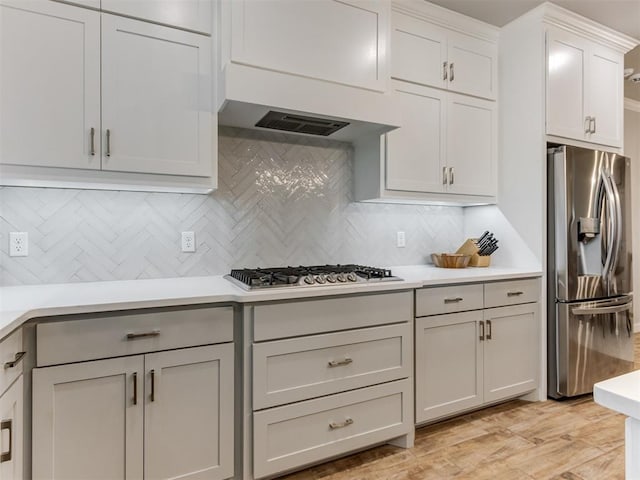 1391 Hickory Trl, Piedmont, OK 73078 - kitchen featuring stainless steel appliances, tasteful backsplash, light countertops, and light wood-style floors