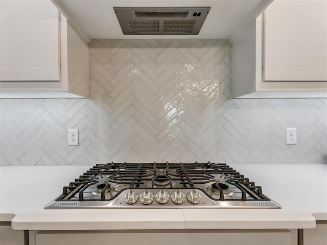 1391 Hickory Trl, Piedmont, OK 73078 - kitchen with stainless steel gas stovetop, extractor fan, light countertops, and decorative backsplash