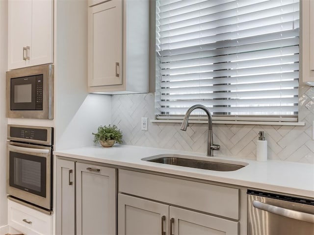 1391 Hickory Trl, Piedmont, OK 73078 - kitchen with appliances with stainless steel finishes, decorative backsplash, and light countertops