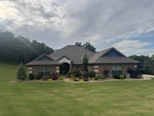 7013 Morning Song Dr, Oklahoma City, OK 73150 - view of front facade with a front yard, brick siding, and a shingled roof