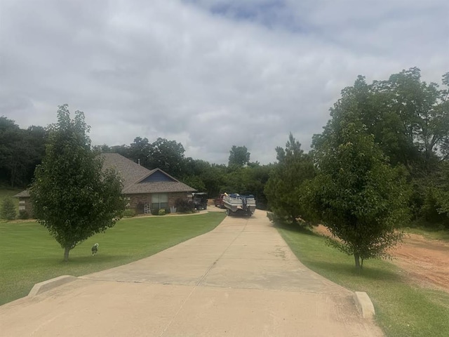 7013 Morning Song Dr, Oklahoma City, OK 73150 - view of home's community featuring a yard and concrete driveway