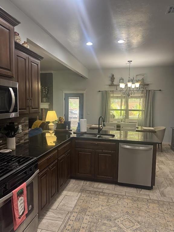 7013 Morning Song Dr, Oklahoma City, OK 73150 - kitchen featuring stainless steel appliances, a chandelier, dark brown cabinetry, backsplash, and recessed lighting