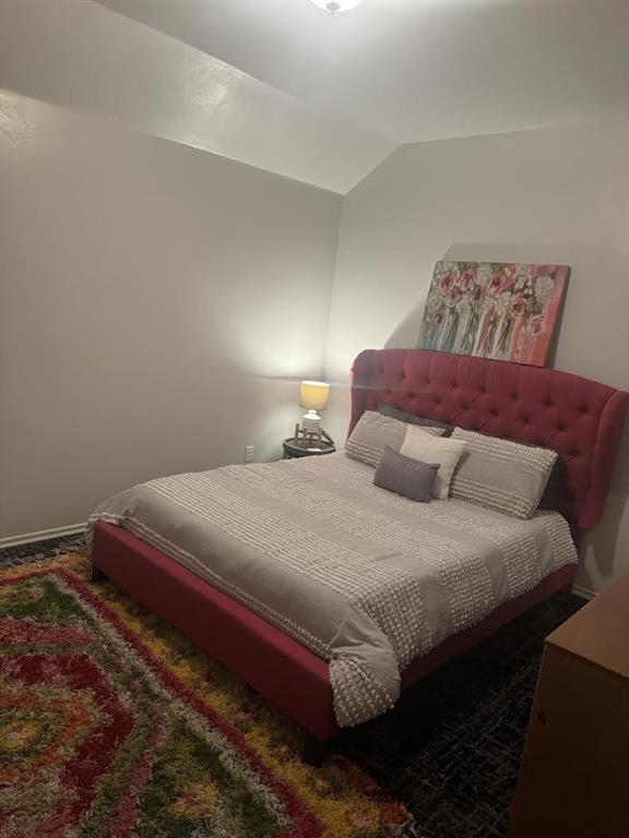 7013 Morning Song Dr, Oklahoma City, OK 73150 - carpeted bedroom featuring lofted ceiling