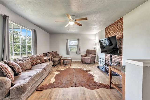 601 N Dobbs Rd, Harrah, OK 73045 - living area with wood finished floors, healthy amount of natural light, ceiling fan, and a textured ceiling