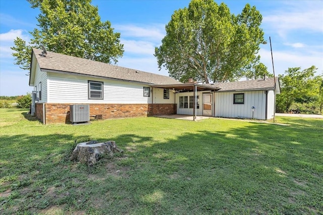 601 N Dobbs Rd, Harrah, OK 73045 - rear view of house with brick siding, a patio area, and a lawn
