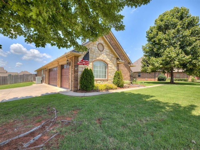 2009 Pembroke Ln, Edmond, OK 73003 - view of front facade with stone siding, concrete driveway, and an attached garage