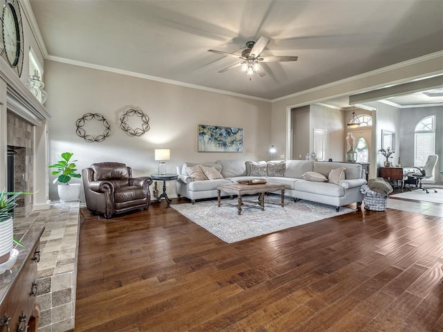 2009 Pembroke Ln, Edmond, OK 73003 - living room featuring a ceiling fan, wood finished floors, a glass covered fireplace, and ornamental molding