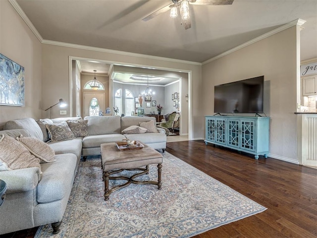 2009 Pembroke Ln, Edmond, OK 73003 - living area with wood finished floors, ornamental molding, a ceiling fan, and a chandelier