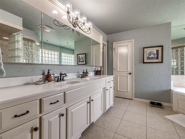 2009 Pembroke Ln, Edmond, OK 73003 - bathroom with double vanity, a bath, and tile patterned floors
