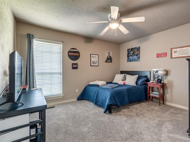 2009 Pembroke Ln, Edmond, OK 73003 - bedroom with multiple windows, carpet floors, and ceiling fan