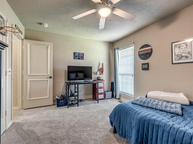 2009 Pembroke Ln, Edmond, OK 73003 - bedroom with a textured ceiling, carpet floors, a textured wall, and ceiling fan