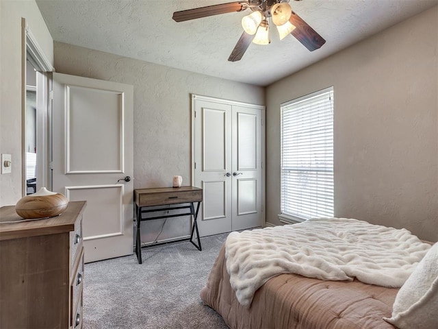 2009 Pembroke Ln, Edmond, OK 73003 - bedroom featuring a textured wall, carpet flooring, a textured ceiling, and a ceiling fan