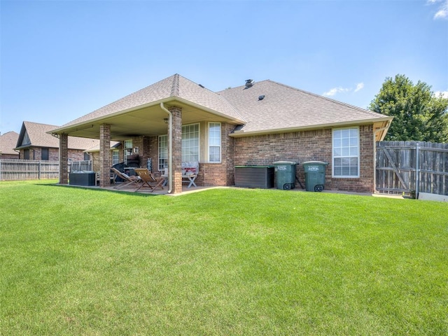 2009 Pembroke Ln, Edmond, OK 73003 - rear view of property with brick siding, a patio, and roof with shingles