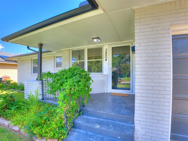 3804 NW 52nd St, Oklahoma City, OK 73112 - doorway to property with brick siding and covered porch