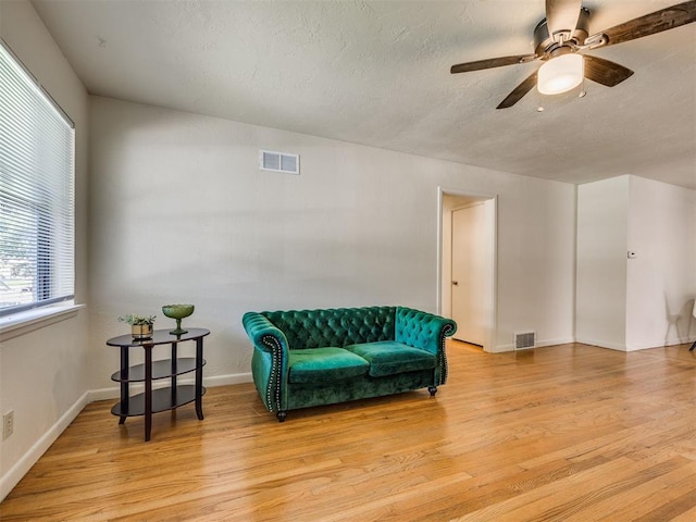 3804 NW 52nd St, Oklahoma City, OK 73112 - living area featuring light wood-type flooring, a ceiling fan, and a textured ceiling