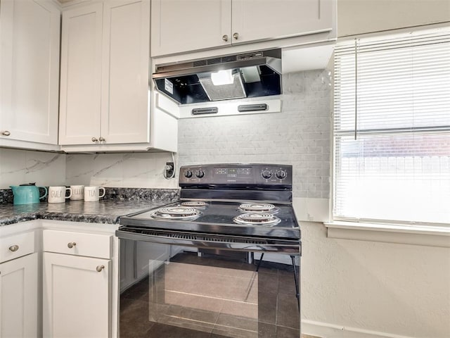 3804 NW 52nd St, Oklahoma City, OK 73112 - kitchen featuring black range with electric stovetop, ventilation hood, tasteful backsplash, dark countertops, and white cabinets