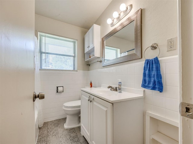 3804 NW 52nd St, Oklahoma City, OK 73112 - bathroom with tile walls, vanity, wainscoting, and tile patterned flooring
