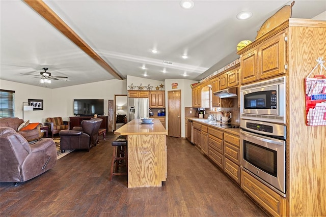 5097 County St Unit 2580, Hinton, OK 73047 - kitchen with appliances with stainless steel finishes, a breakfast bar, open floor plan, recessed lighting, and light countertops