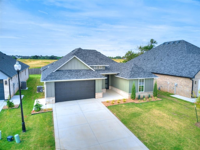 216 Pont Neuf Ct, Edmond, OK 73034 - view of front facade featuring a shingled roof, a garage, board and batten siding, concrete driveway, and brick siding