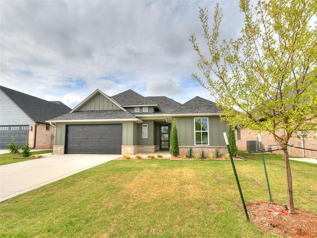 216 Pont Neuf Ct, Edmond, OK 73034 - view of front of home featuring board and batten siding, brick siding, an attached garage, driveway, and a shingled roof