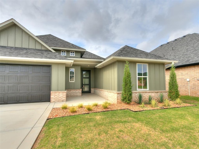 216 Pont Neuf Ct, Edmond, OK 73034 - view of front facade with brick siding, board and batten siding, a garage, a front lawn, and driveway