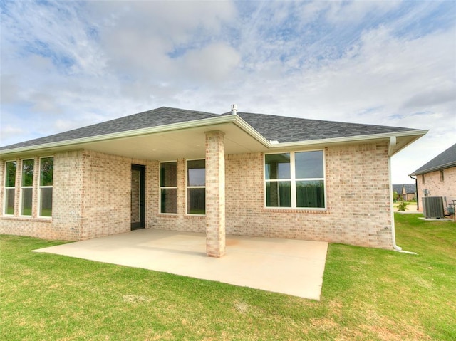 216 Pont Neuf Ct, Edmond, OK 73034 - rear view of property with a lawn, a patio, brick siding, and roof with shingles