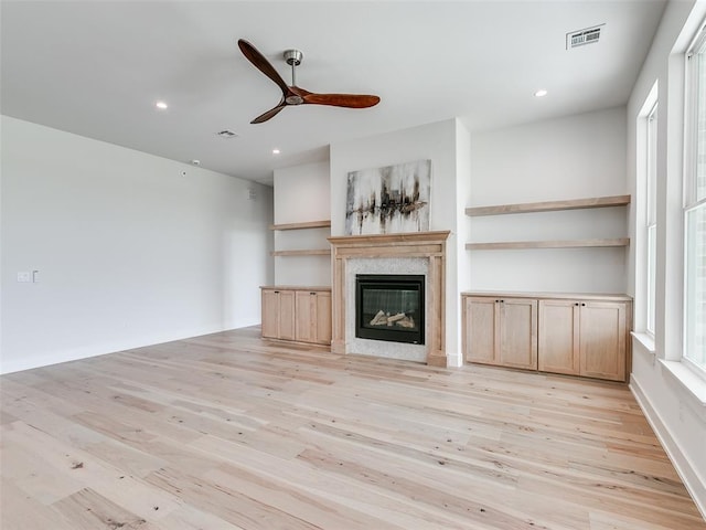 216 Pont Neuf Ct, Edmond, OK 73034 - unfurnished living room with light wood-style flooring, a ceiling fan, a fireplace, and recessed lighting