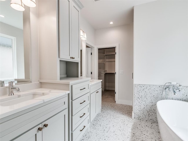 216 Pont Neuf Ct, Edmond, OK 73034 - bathroom featuring vanity, a soaking tub, a walk in closet, and recessed lighting