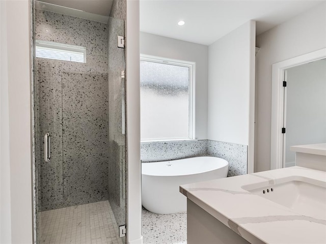 216 Pont Neuf Ct, Edmond, OK 73034 - bathroom with vanity, a freestanding tub, a stall shower, and recessed lighting