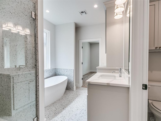 216 Pont Neuf Ct, Edmond, OK 73034 - bathroom featuring double vanity, a freestanding tub, and recessed lighting