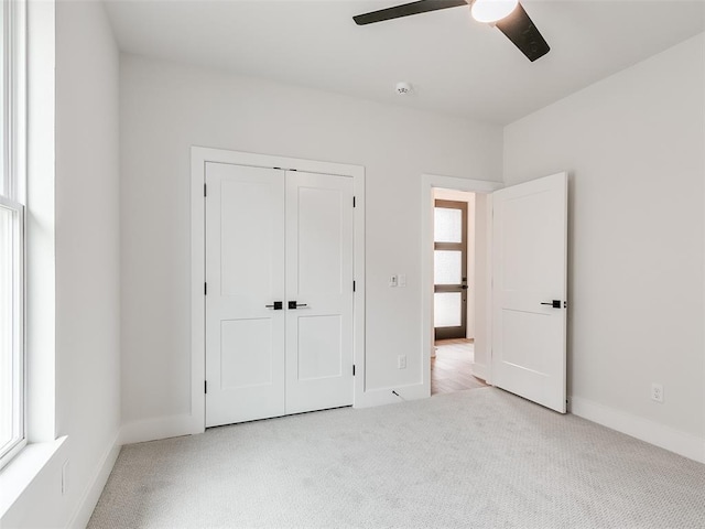 216 Pont Neuf Ct, Edmond, OK 73034 - unfurnished bedroom featuring carpet floors, a closet, and a ceiling fan
