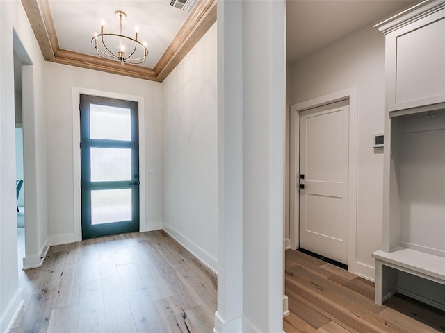 216 Pont Neuf Ct, Edmond, OK 73034 - foyer entrance featuring a chandelier, light wood-style flooring, and crown molding