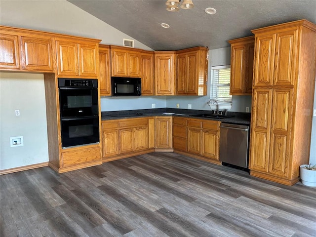 kitchen with black appliances, dark wood-type flooring, lofted ceiling, dark countertops, and brown cabinets