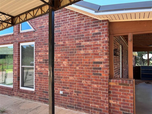 view of side of home featuring brick siding