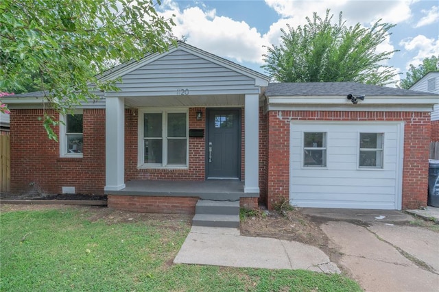 1120 SW 47th St, Oklahoma City, OK 73109 - view of front of house with covered porch, brick siding, and a front yard