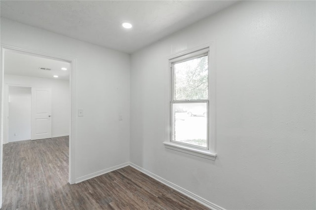 1120 SW 47th St, Oklahoma City, OK 73109 - empty room featuring dark wood finished floors, healthy amount of natural light, and recessed lighting