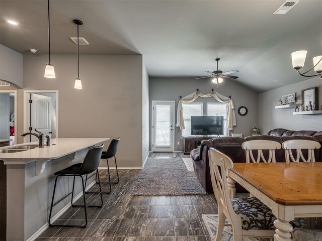 12812 Double V Dr, Piedmont, OK 73078 - dining space with ceiling fan, arched walkways, and vaulted ceiling