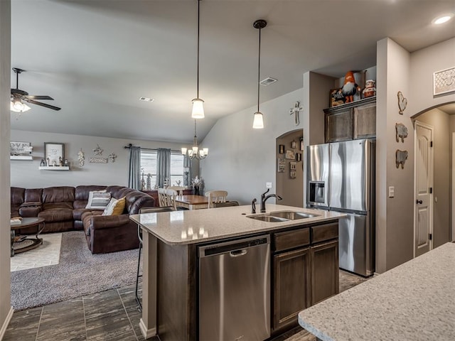 12812 Double V Dr, Piedmont, OK 73078 - kitchen featuring stainless steel appliances, arched walkways, a ceiling fan, dark brown cabinetry, and decorative light fixtures