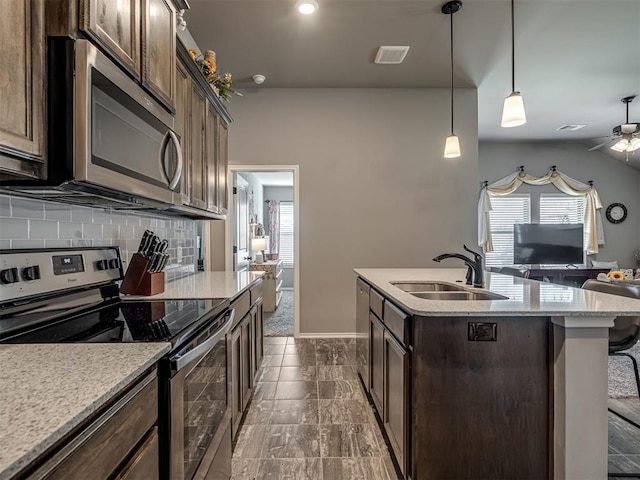 12812 Double V Dr, Piedmont, OK 73078 - kitchen featuring appliances with stainless steel finishes, backsplash, open floor plan, a ceiling fan, and dark brown cabinetry